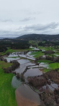 Vertical shot of river flood plain valley during floods in the winter