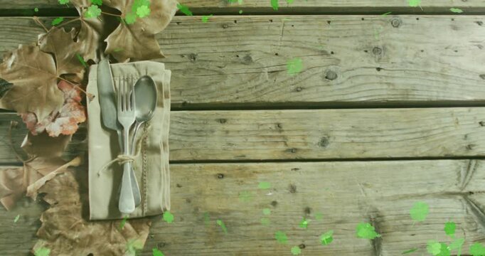 Green paint splats spreading across rustic table, triggered by top center speck, showing cutlery
