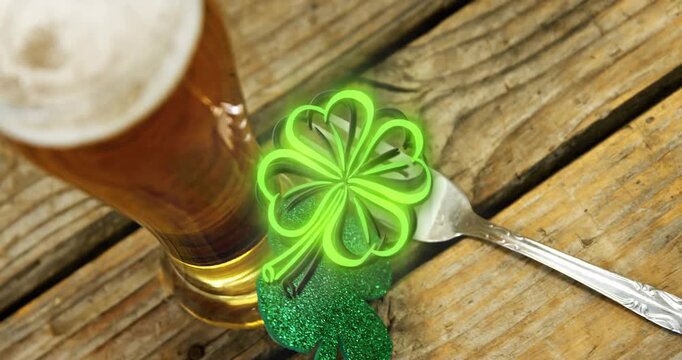 Black clover outline appearing and filling neon green, drawing focus to beer drifting over fork