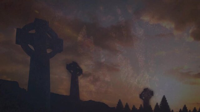 Dusk deepening clouds drifting horizon brightening faint stars peeking Celtic crosses in silhouette