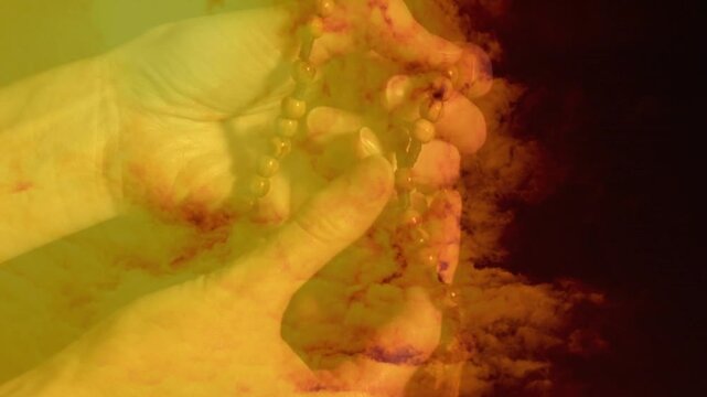 Fingers relaxing and thumb walking, hands sliding beads down, revealing pendant amid cloud wash