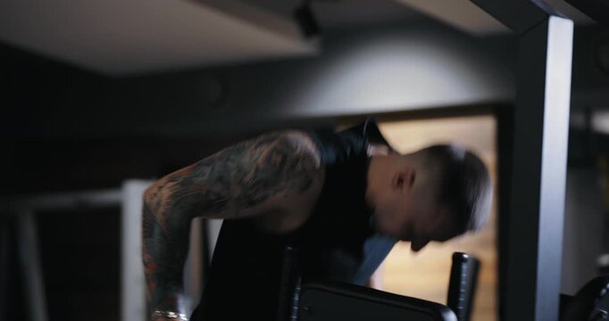 A man doing bar dips exercise pumping his muscles in the gym