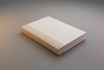 Fototapeta premium Blank hardcover book with a linen spine and paper cover lying on a gray surface, studio lighting for template and design mockup