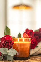 Obraz premium Warm candle flames among roses in soft bokeh. Romantic glow.