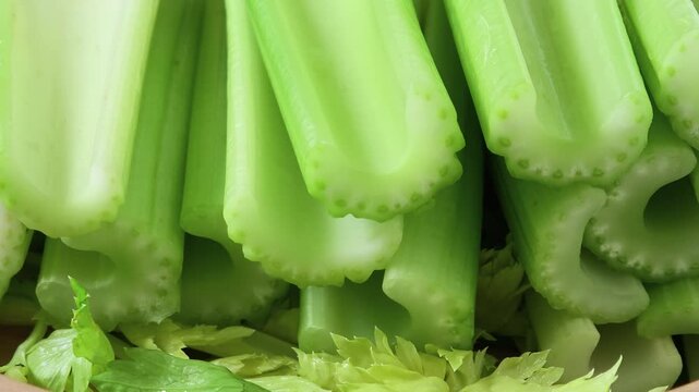 Fresh celery in a wooden bowl.	