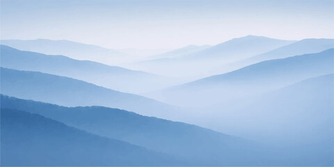 A misty morning sunrise illuminates a blue mountain range where fog and clouds drift over the forest valley and hills in a serene winter nature landscape © sabrina