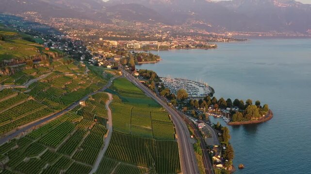 Montreux, Switzerland: Aerial footage of road and railroad track along the the Lavaux vineyard near Vevey and Montreux by the Riveria of lake Geneva in Canton Vaud, Switzerland