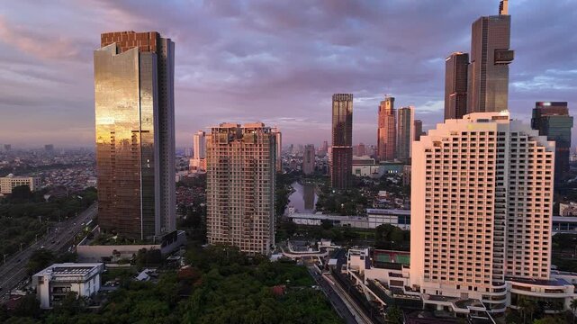 Jakarta, Indonesia: Dramatic sunset over Jakarta downtown and business district in Indonesia capital city. Shot with a tilt up motion. 