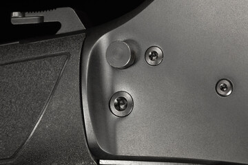 Hammer and safety on a flat black lever-action rifle