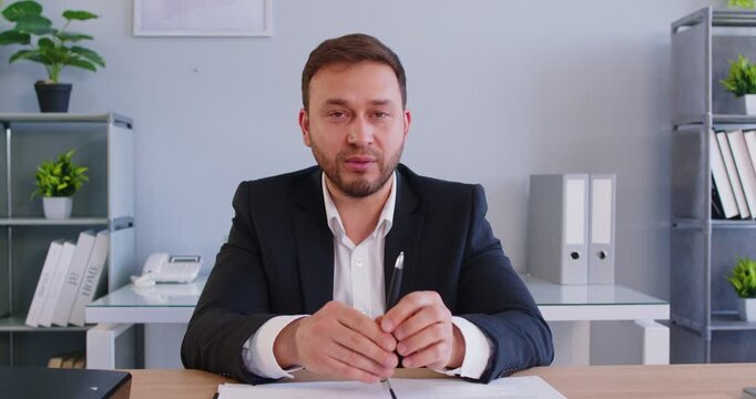 Professional experienced male lawyer making speech, explaining some legal issues, posing in modern office, talking wuith client, having corporate career, making presentation offer.