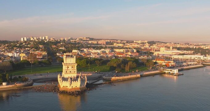 Bel&eacute;m Tower on Tagus River in Lisbon at golden hour, aerial drone close wide shot, Portugal