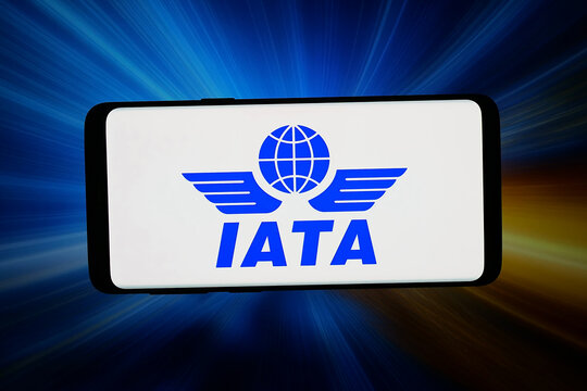 Stuttgart, Germany - 02-19-2026: In this photo illustration, the logo of International Air Transport Association IATA is displayed on a smartphone in front of abstract background on computer screen.