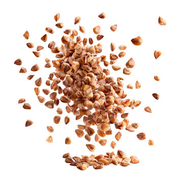 Pile of buckwheat groats exploding and falling against a white background