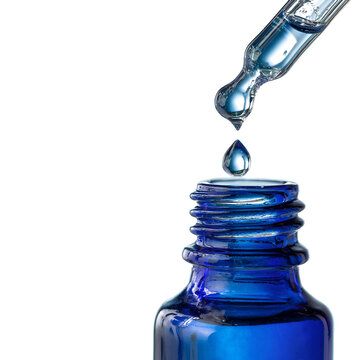 Blue glass bottle with dropper dispensing liquid drop