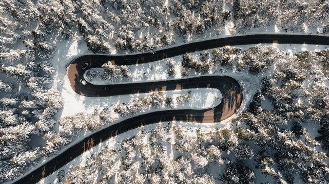 Mount Parnassus mountain winding road covered in snow winter in Greece, aerial drone top down view