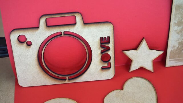 Precision laser cutting and engraving on MDF, shapes on red surface
