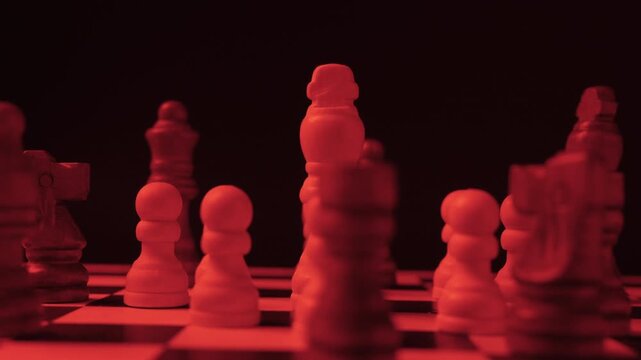 Cinematic circular camera movement around a chess king shielded by pawns but encircled by enemy pieces under intense red lighting, symbolizing tension, siege and imminent conflict.