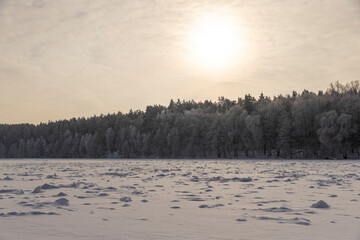 a frozen wide river covered with ice during the frosts, a river covered with pure white fresh snow after snowfalls and frosts