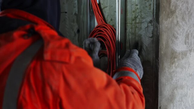 Technician fastening network cables with zip ties