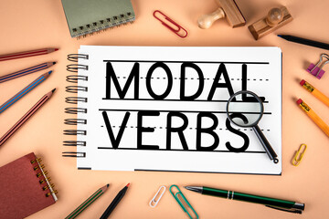 Modal Verbs Text On Notebook Page With Magnifying Glass Education Concept