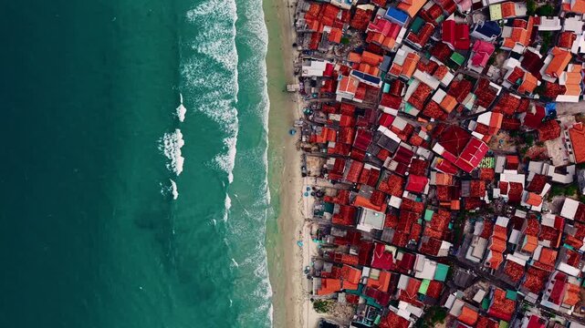 Vibrant coastal Doc Let village in vietnam with red tiled roofs and turquoise sea.