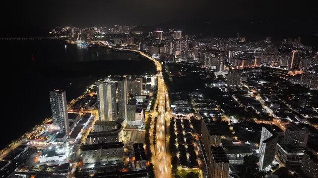 Drone aerial night light trail over George Town cityscape