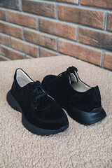 Elegant black leather womens shoes blank product for branding displayed. New casual female sneakers no-brand footwear e-commerce. No logo product unbranded fashion