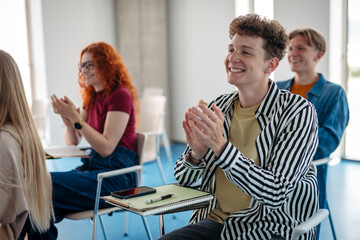 Fototapeta premium Group of college students attending lecture in university hall.