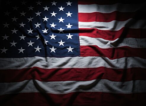 American flag with dramatic shadows, crumpled fabric texture of United States flag, patriotic background for Memorial Day and Veterans Day