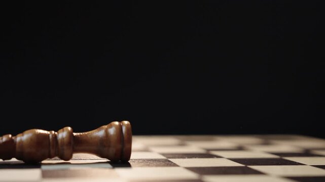Cinematic chess scene with circular camera movement as one king enters and knocks down another representing business competition leadership change takeover strategy and power transition concept