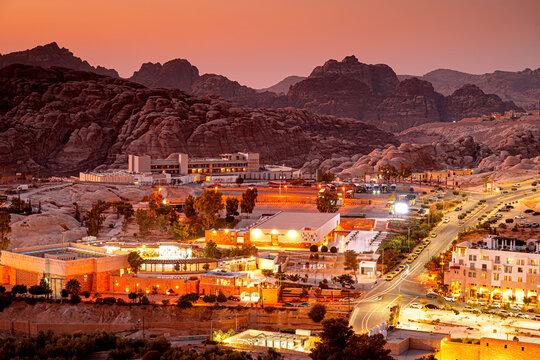 Night view of Petra, an illuminated town in Jordan with mountains.  Tourist attraction in Middle East at dusk.