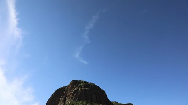 Tilt down shot from blue sky to the massive volcanic peak of an Adwa mountain in Tigray Ethiopia