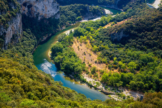 Panoramic view of the famous Ard&egrave;che Gorge &ldquo;R&eacute;serve Naturelle Nationale des Gorges de l'Ard&egrave;che&rdquo; in southern France. The pristine river meanders through a karst landscape with steep limestone cliffs. 