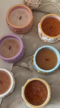  Handmade soy wax candles with golden wax in exquisite candlesticks, close-up of different stages of wax hardening for luxurious decorative concepts
