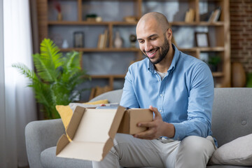Cheerful customer receiving and unboxing a delivery package from an online store, a joyful...