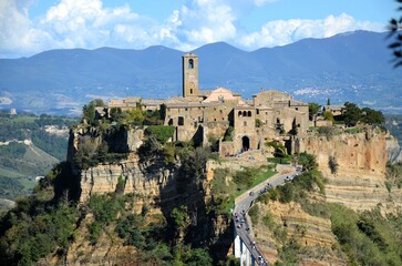 Fototapeta premium The famous Civita di Bagnoregio on a sunny day. Province of Viterbo, Lazio, Italy. Medieval town on the mountain, Civita di Bagnoregio, popular touristic stop at Tuscany, Italy