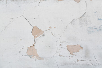 Old wall with cracked plaster. Weathered rough surface. Vintage texture is perfect for background and design.