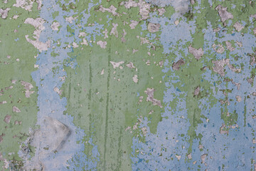 Peeling paint on the wall. Old concrete wall with cracked flaking paint. Weathered rough painted surface with patterns of cracks and peeling. High resolution texture for background and design. Closeup