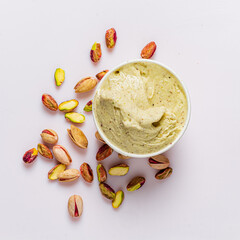 Delicious pistachio ice cream is surrounded by whole pistachio nuts, creating a tempting treat