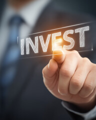 a businessman's hand touching the word "invest" , digital and online investment concept