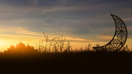 A beautiful silhouette of a mosque and an ornate crescent moon in a field during a vibrant golden sunset. Ideal for Ramadan Kareem, Eid Mubarak, and Islamic religious celebrations