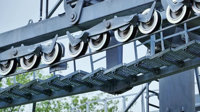 Cable car pulleys guiding steel rope on an industrial lift mechanism