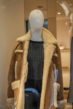 Milan, Italy - 2026, 17 Feb: Maison Margiela SS26 shearling coat and textured knit dress displayed in a chic boutique window, highlighting modern luxury and refined style