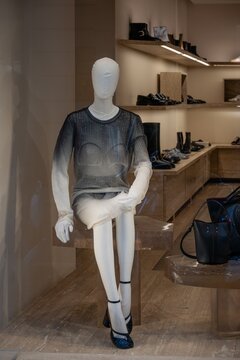 Milan, Italy - 2026, 17 Feb: Maison Margiela SS26 display features a sheer sweater on a mannequin, set in a modern boutique with chic accessories and minimalist decor