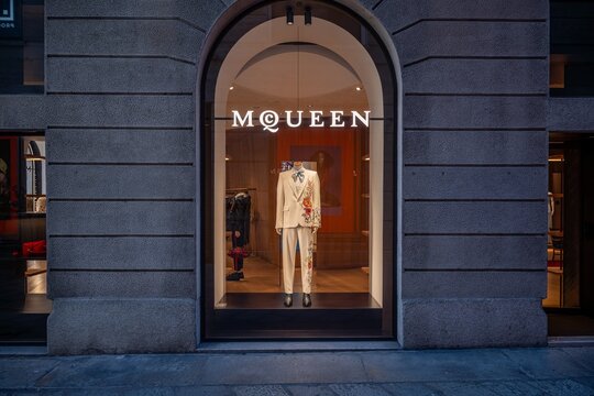 Milan, Italy - 2026, 17 Feb: Striking McQueen SS26 window display features a floral suit in a luxury boutique, blending modern elegance with iconic Milanese style