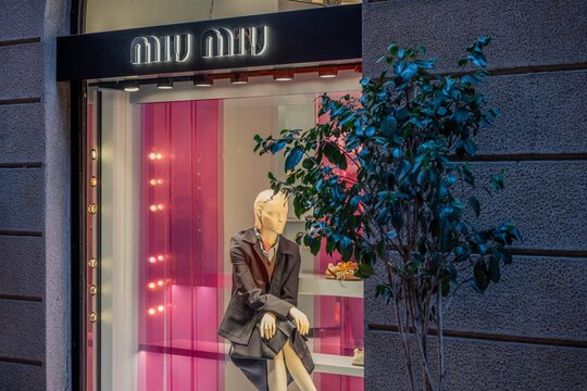 Milan, Italy - 2026, 17 Feb: MIU MIU SS26 boutique window with chic mannequin, modern pink accents, and luxury fashion display in a vibrant urban setting