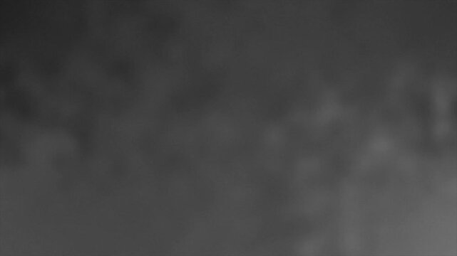Blurry black and white abstract background with shades of gray.