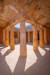 Fototapeta premium Tombs of the Kings, historical grave necropolis with ancient stone ruins and caves, cyprian archaeological site at scenic sea coast and old tourist landmark attraction, Paphos, Cyprus, Europe.