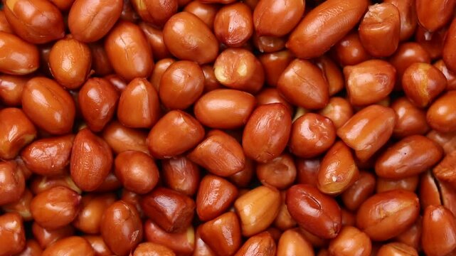 Top view of crispy brown fried peanuts rotating slowly.