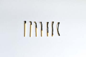 Burnt matches over white background